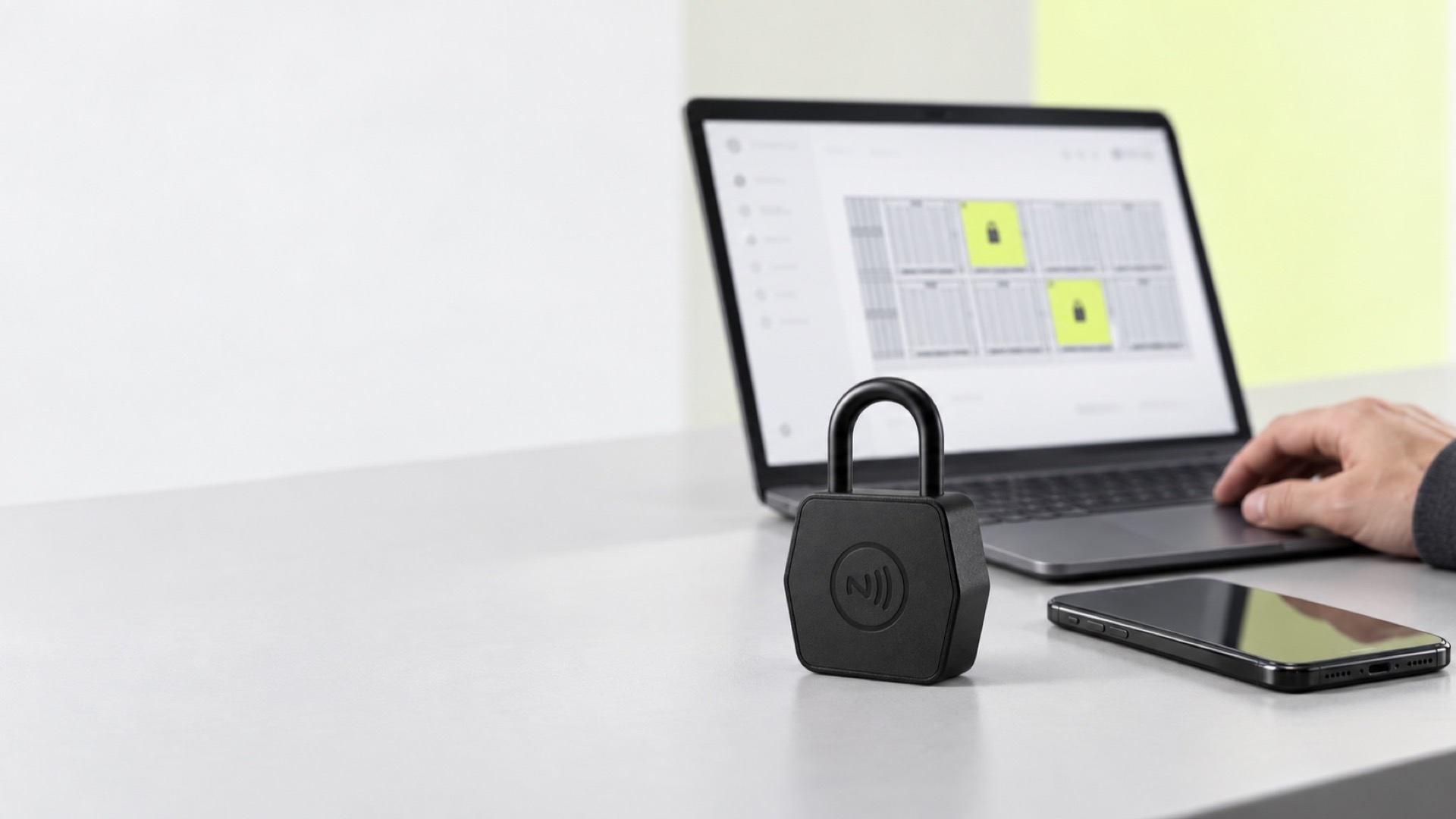The management console open on a laptop beside an NFC padlock