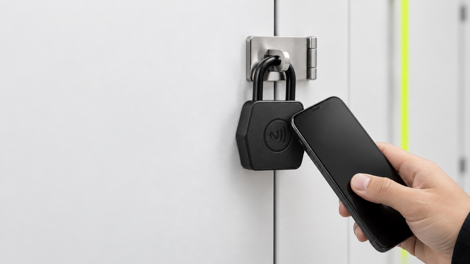A phone held at the NFC area of a padlock on a locker door